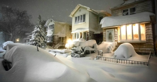 lit up house during snow storm